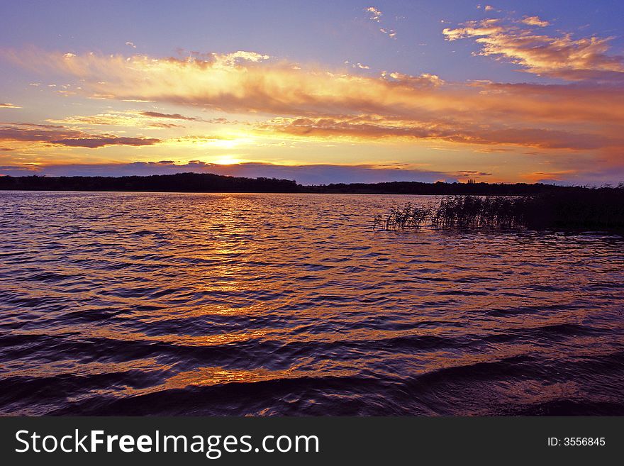 The coming sun on a background of lake. The coming sun on a background of lake