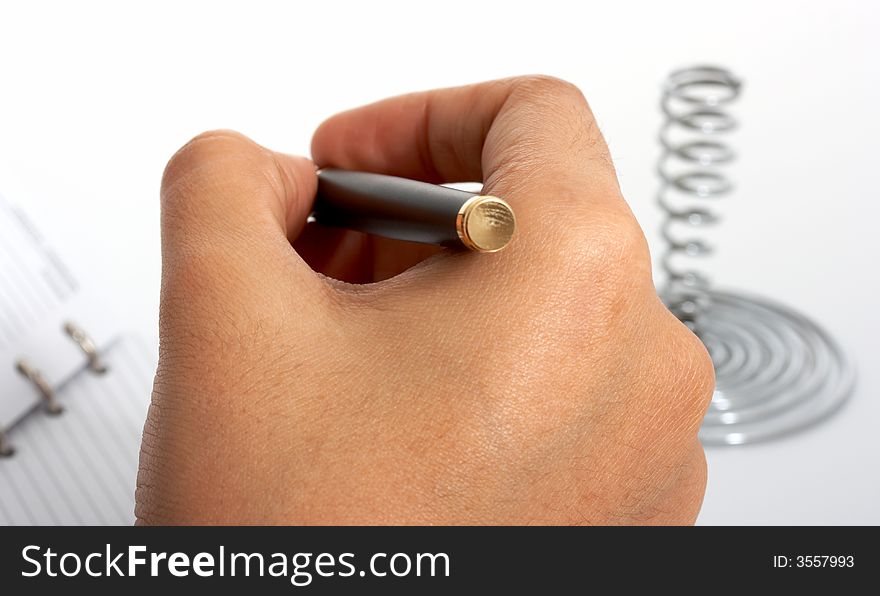 A pen and an organizer over a white background. A pen and an organizer over a white background