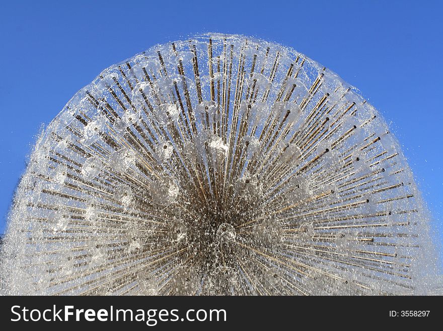 Water fountain on a background of the dark blue sky