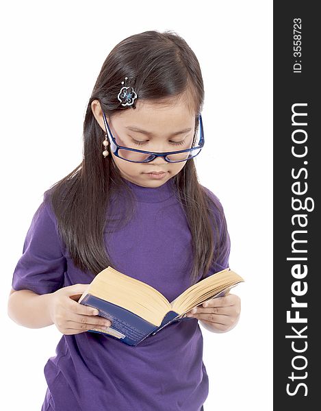 A young girl reading a book over a white background