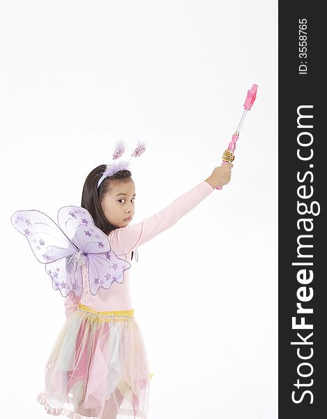 A girl wearing a fairy costume over a white background