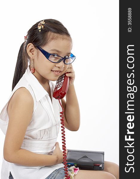 A young girl talking on the phone. A young girl talking on the phone