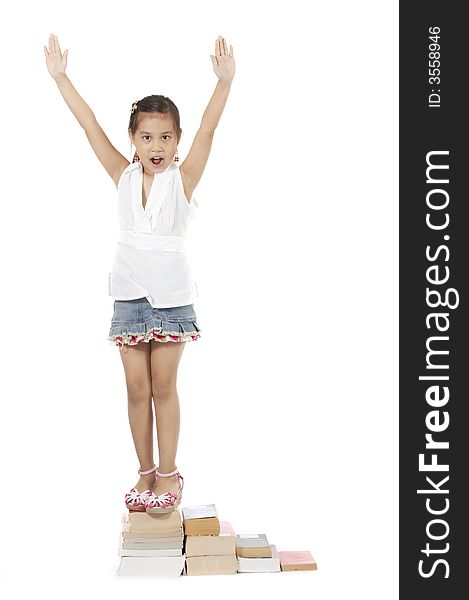 A girl climbing up by stepping on book stacks. A girl climbing up by stepping on book stacks