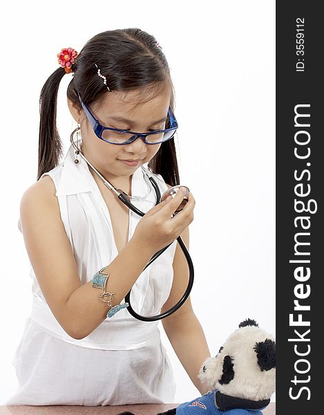 A girl playing doctor over a white background