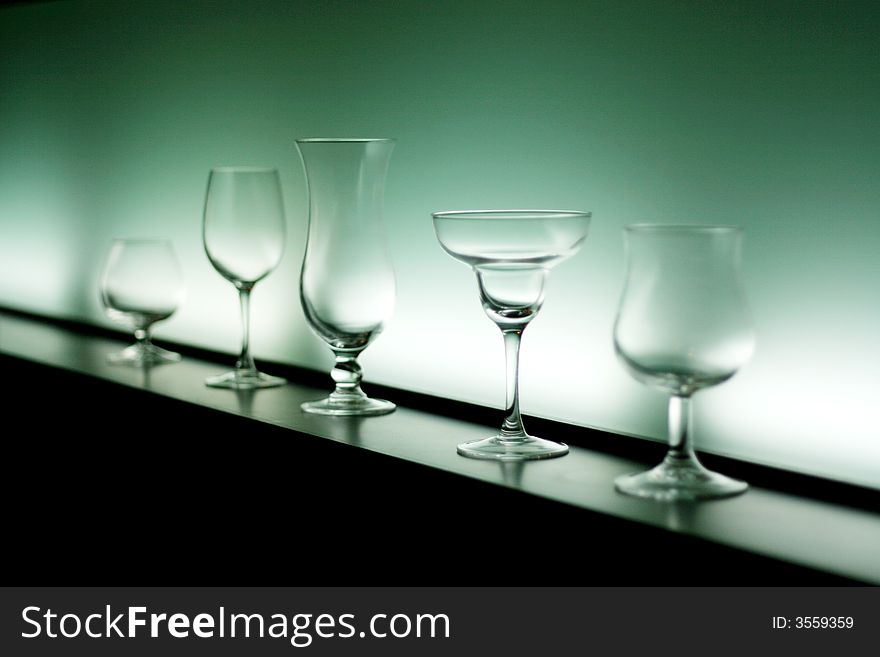 Five shapes of empty cocktails glass, selective focus on fourth glass. Five shapes of empty cocktails glass, selective focus on fourth glass