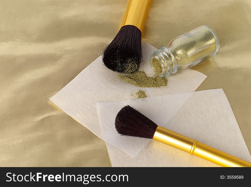 Brushes and shine on a gold fabric. Brushes and shine on a gold fabric