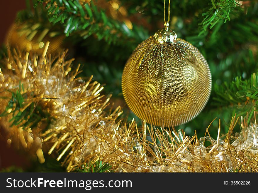 Christmas decoration on the tree with gold chain