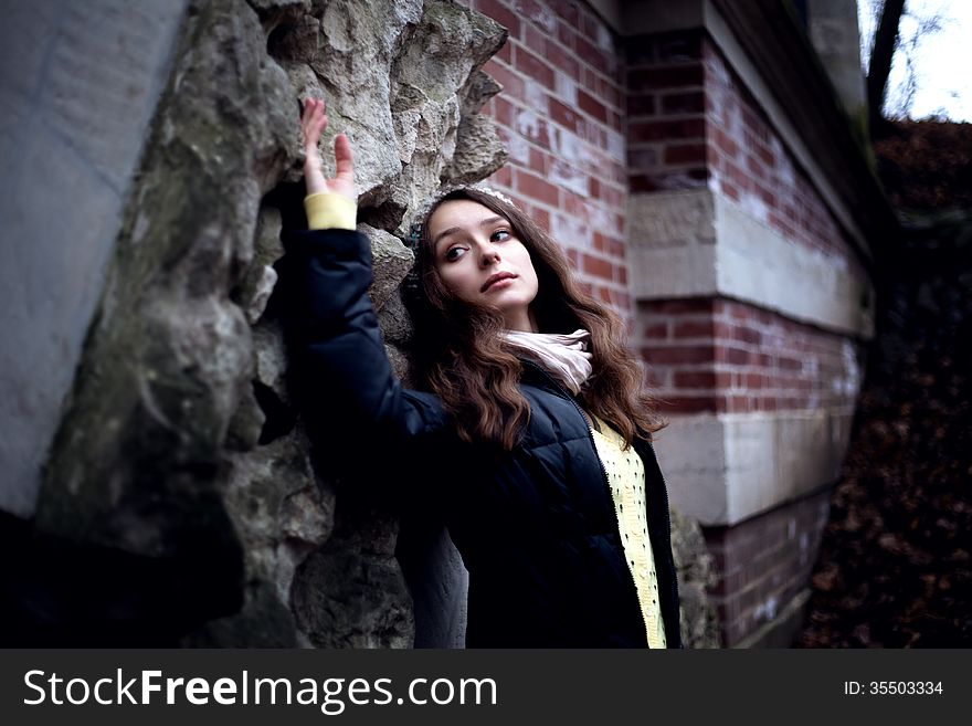 Woman in dark cold stone background