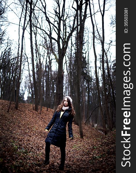 Woman In Dark Cold Forest Background