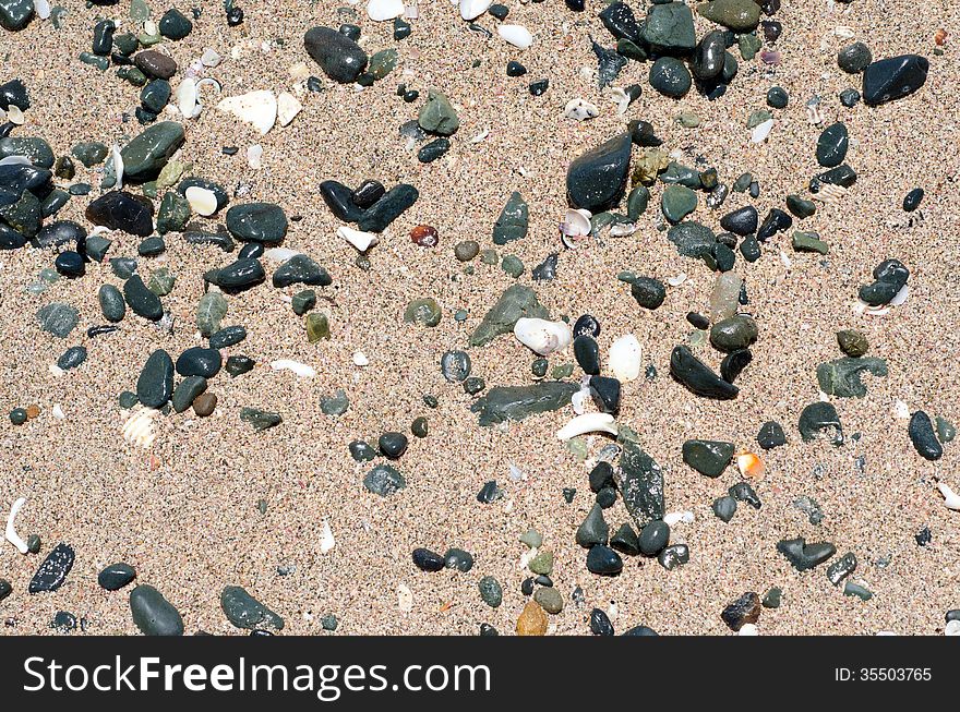 Stones on sand. Summer beach background. Top view