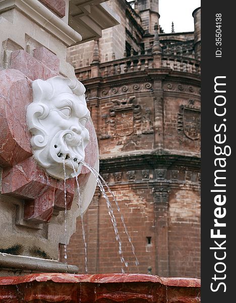 Ancient fountain against La Giralda Cathedral. Seville, Spain