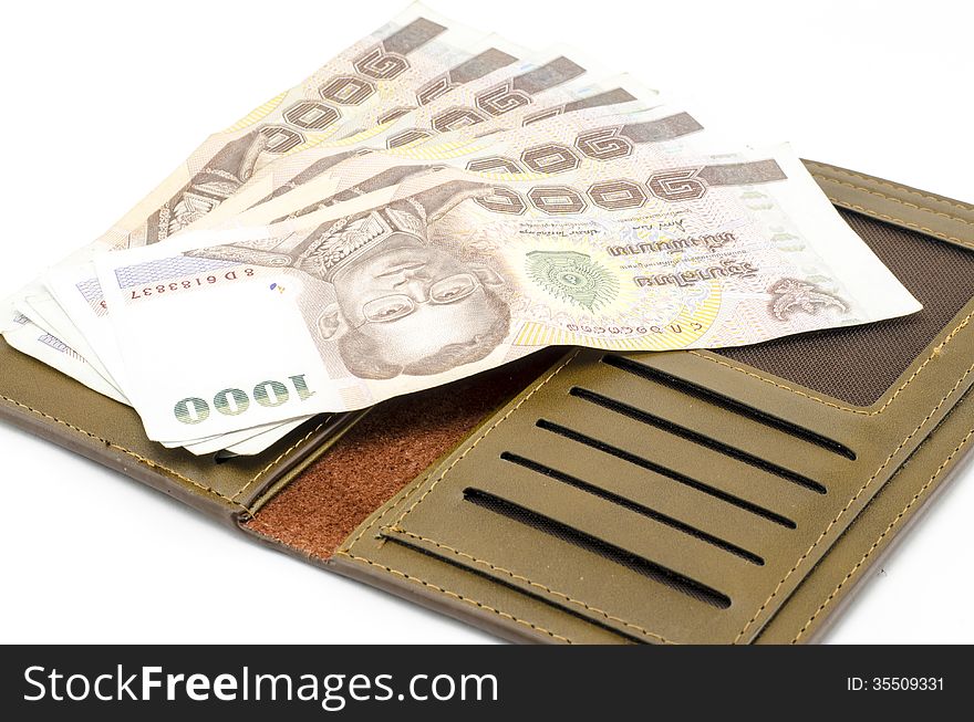 Thai banknote in brown wallet isolated on white background