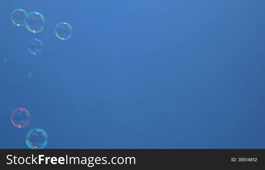 Bubbles in front of a blue sky background. Bubbles in front of a blue sky background