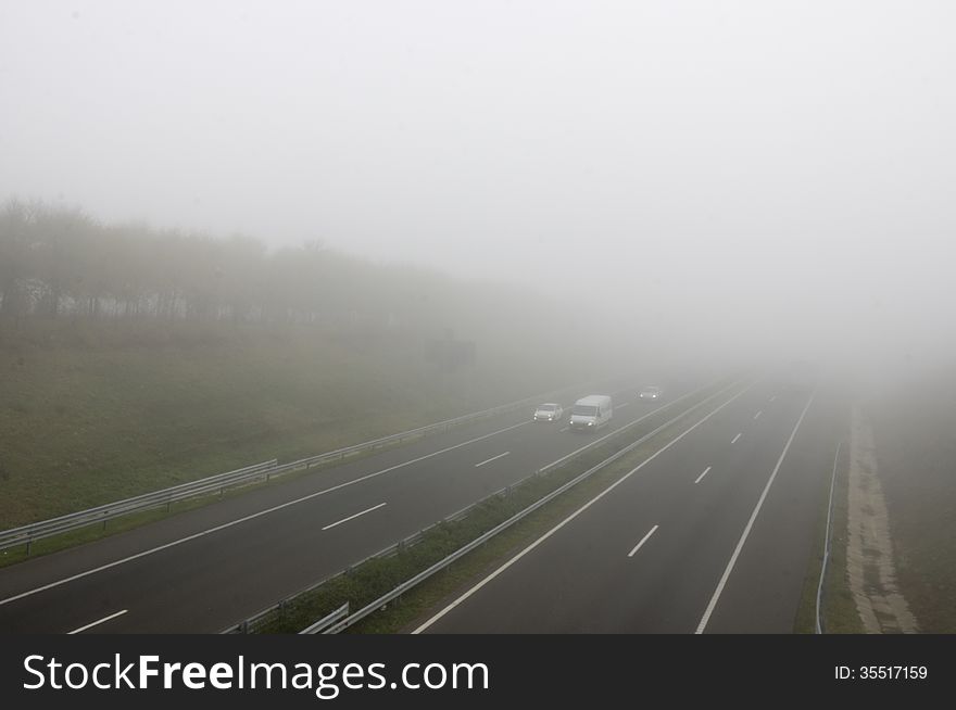 Foggy highway with three cars. Foggy highway with three cars.
