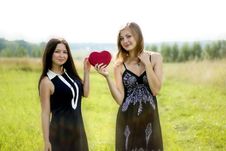 Two Pretty Women With Red Heart In Sunshine Summer Field Royalty Free Stock Image Two Pretty Women With Red Heart In Sunshine Summer Field Royalty Free Stock Image