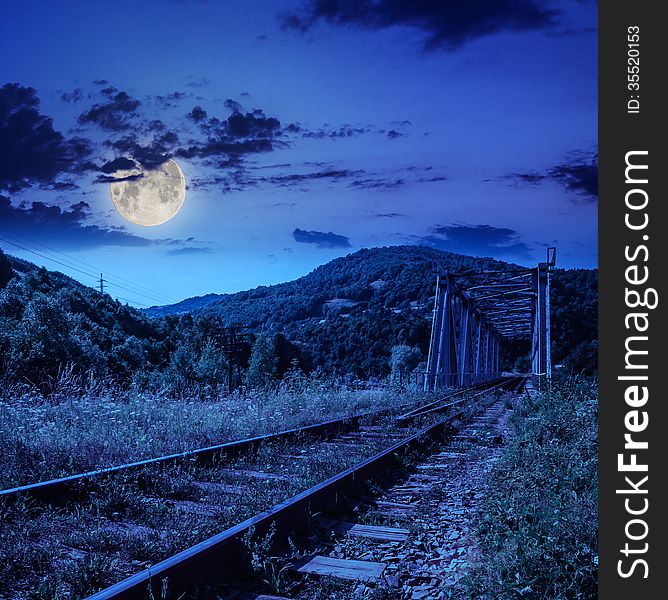 Mountains landscape. rail metal bridge in moon light. Mountains landscape. rail metal bridge in moon light