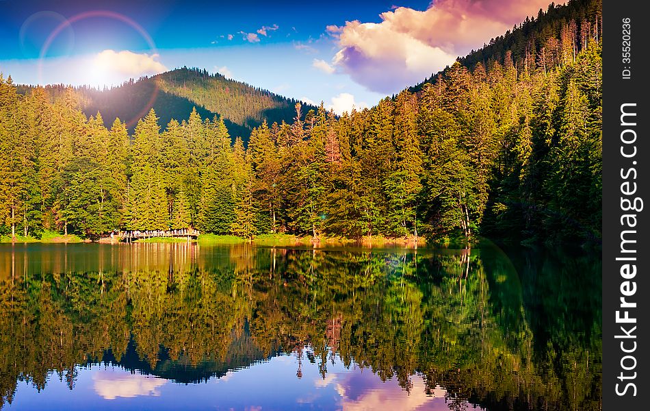 Mountain lake near coniferous fotest at the mountain foot. Mountain lake near coniferous fotest at the mountain foot