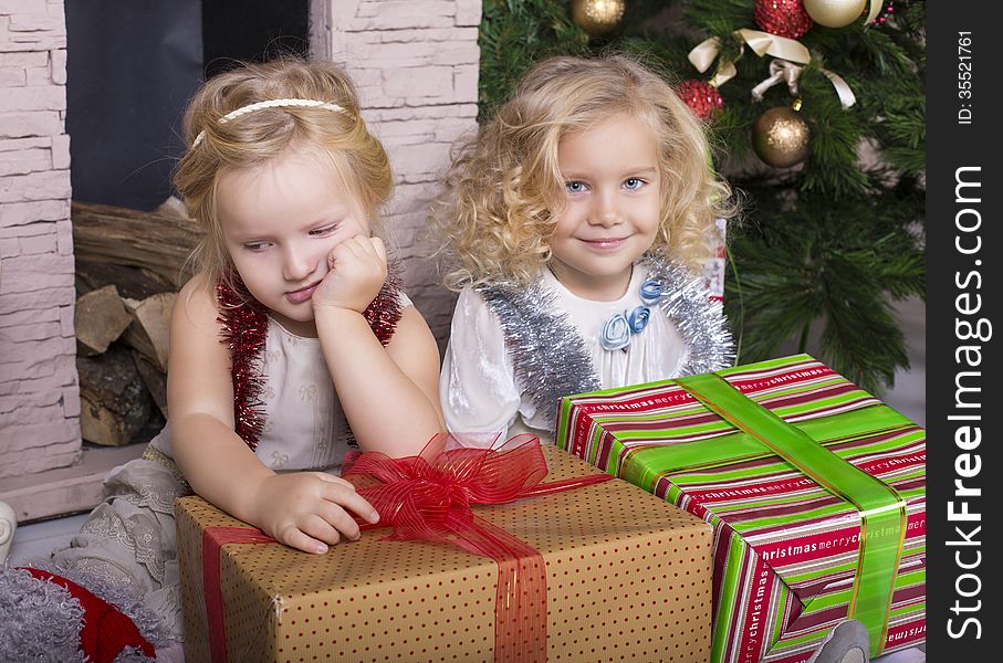 Funny little girls with Christmas gifts. Funny little girls with Christmas gifts