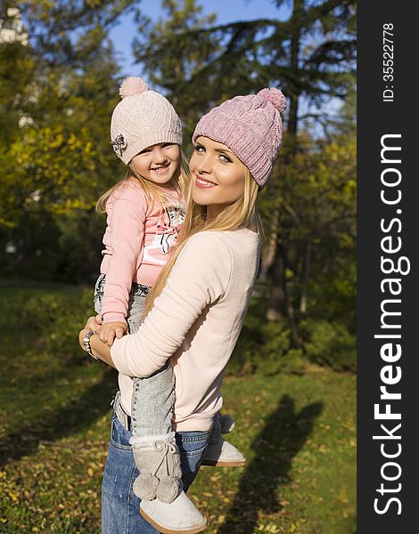 Mother and her little girl having fun in park