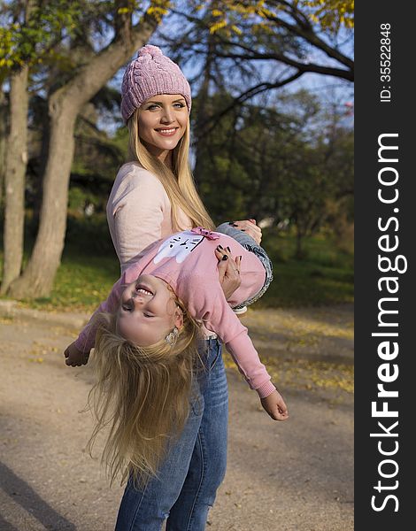 Mother and her little girl having fun in park