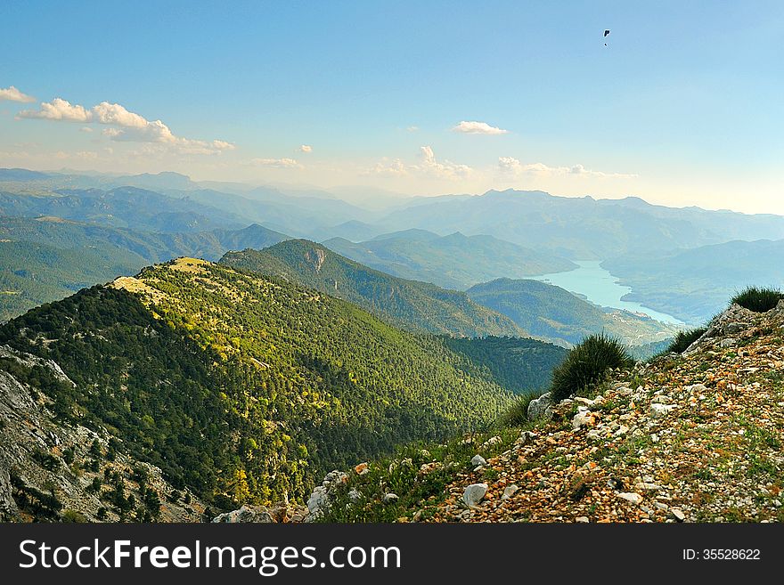 Paraglider flying over the mountains in Spain. Paraglider flying over the mountains in Spain