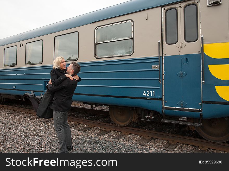 Big hug beside train carriage