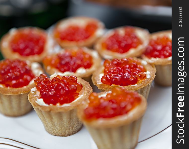 Red caviar in baskets of dough