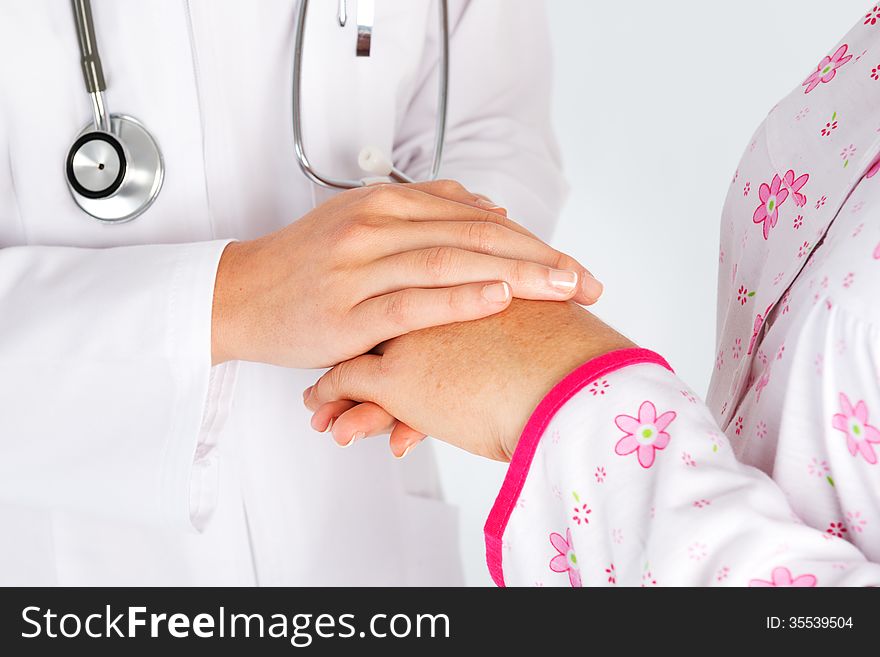 Holding patient hand in hospital