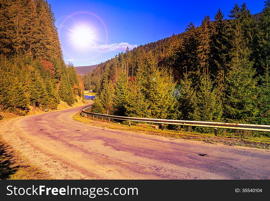 Empty asphalt mountain road near the coniferous forest. Empty asphalt mountain road near the coniferous forest