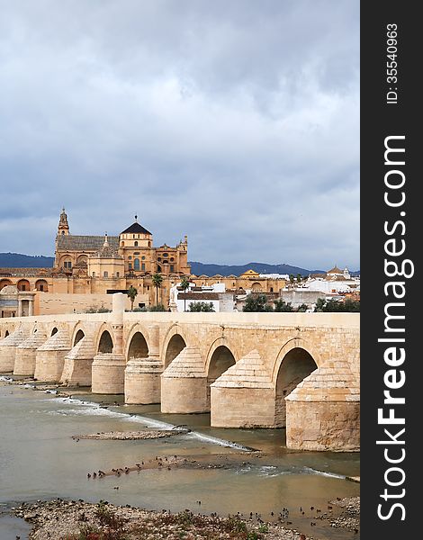 View at ancient Cathedral and bridge across Guadalquivir river in Cordoba, Spain