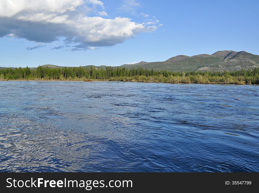 Water summer landscape surrounding the river Suntar in the Highlands of Oymyakon, Yakutia, Russia. Water summer landscape surrounding the river Suntar in the Highlands of Oymyakon, Yakutia, Russia.