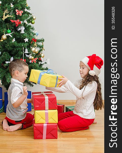 Brother and sister packing christmas gifts