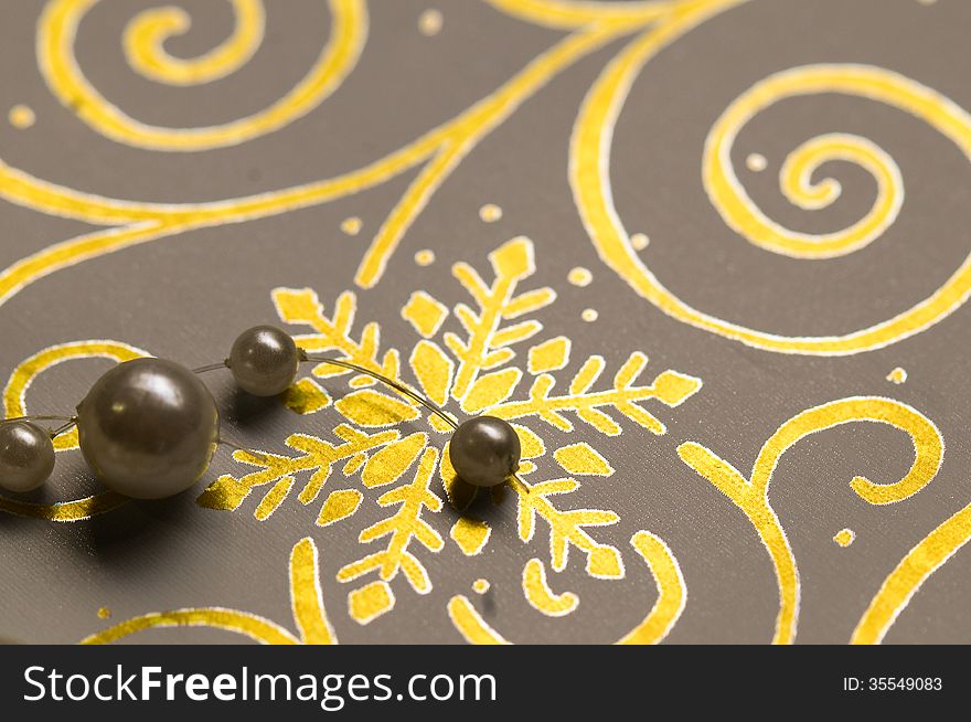 Gold Christmas snowflake theme print with pearly baubles. Gold Christmas snowflake theme print with pearly baubles.