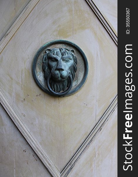 Lock to knock on the wooden door with a lion head. Lock to knock on the wooden door with a lion head