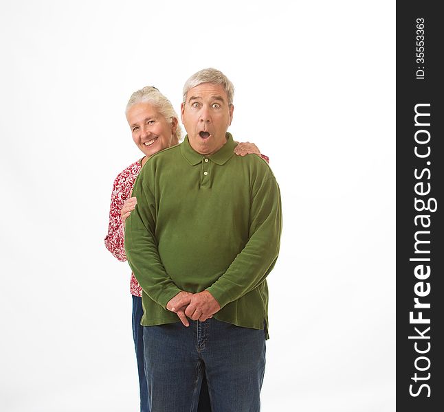 An elderly couple isolated on a white background with happy and surprised expressions. An elderly couple isolated on a white background with happy and surprised expressions