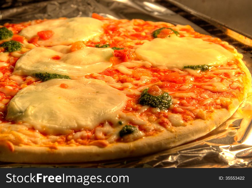 Mozzarella and spinach pizza in an oven