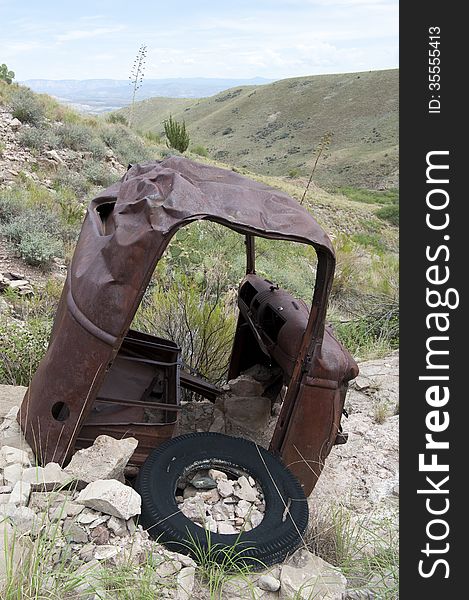 Old rusty car on hill