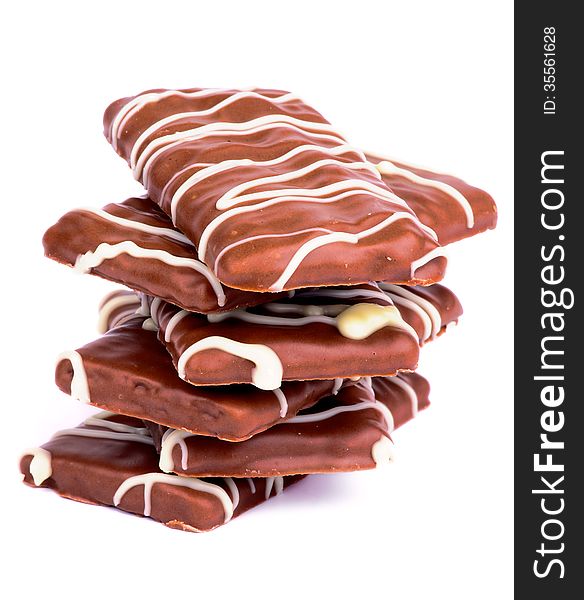 Stack of Chocolate Biscuits with Striped Milk Chocolate Glazed isolated on white background