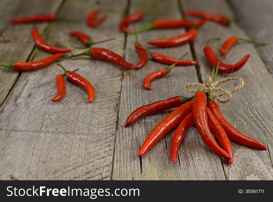 Red hot chili peppers background on wooden table