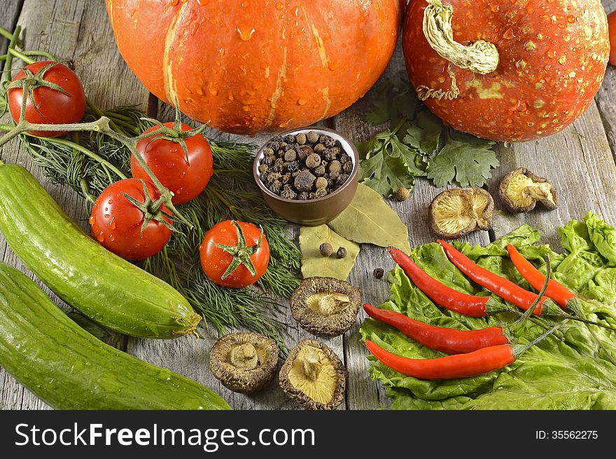 Vegetarian products still life with pumpkins on wood. Vegetarian products still life with pumpkins on wood