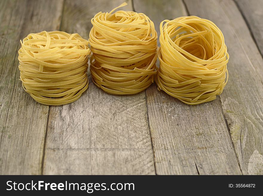 Group of rolled noodles on the wooden table. Group of rolled noodles on the wooden table