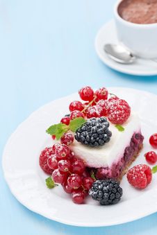 Piece Of Cake With Fresh Berries And Coffee On Blue Background Royalty Free Stock Photography