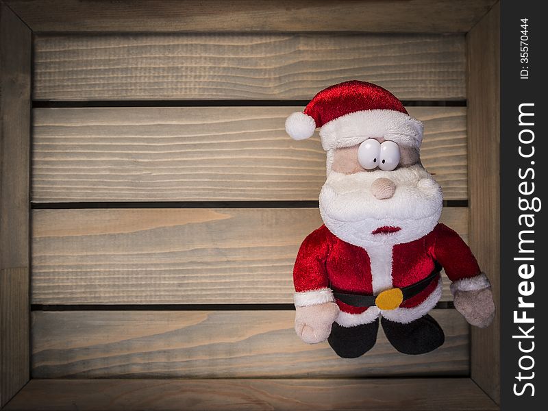 Toy Santa Claus on the wooden background