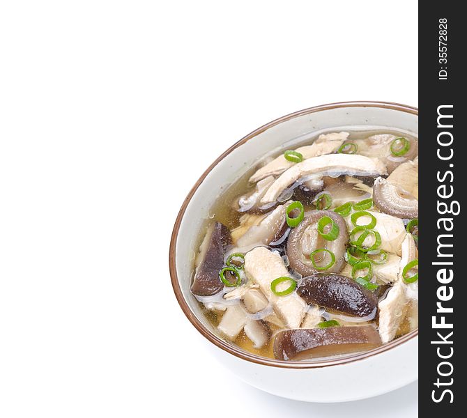 Chinese soup with chicken, shiitake mushrooms and green onions, close-up, isolated on white