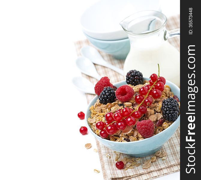Delicious homemade granola with fresh berries and milk, isolated on white