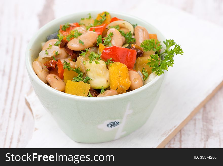 Vegetable stew with beans in a bowl, close-up