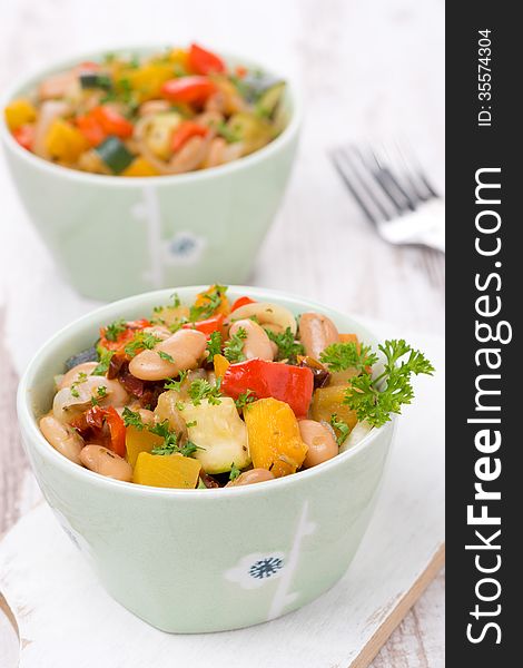 Vegetable stew with beans in the bowls, vertical