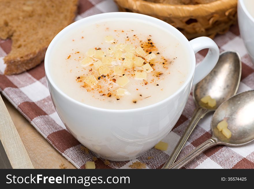 Delicious cream soup of cauliflower with cheese and pepper, top view, horizontal
