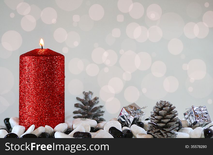 Christmas light with red candle, pinecones and gifts