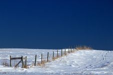 Fence Line On Snow Covered Ground Stock Photography
